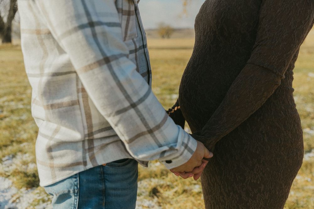 Close-up of casual clothing details during an intimate outdoor photoshoot.