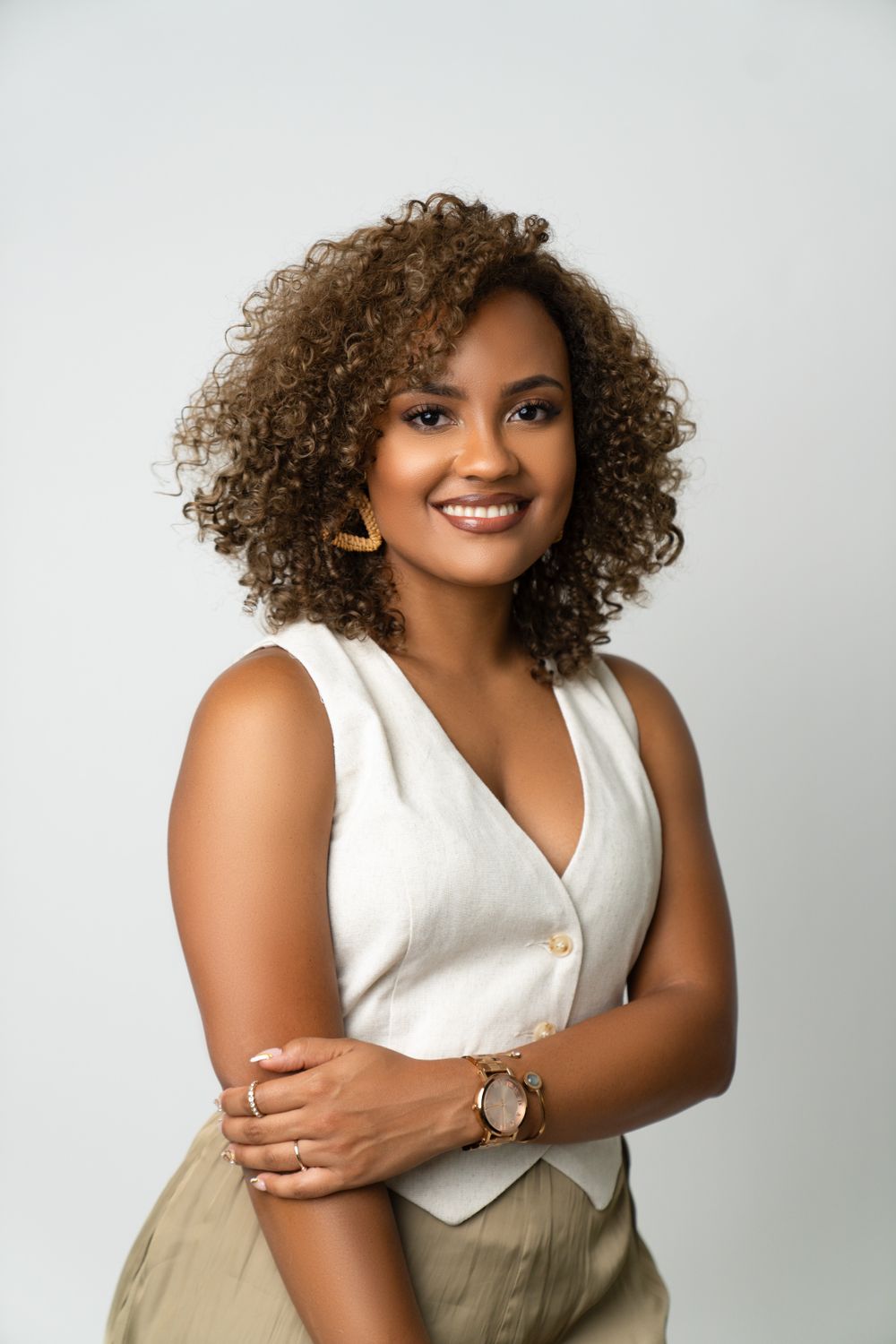 Professional headshot against white background showcasing natural style.