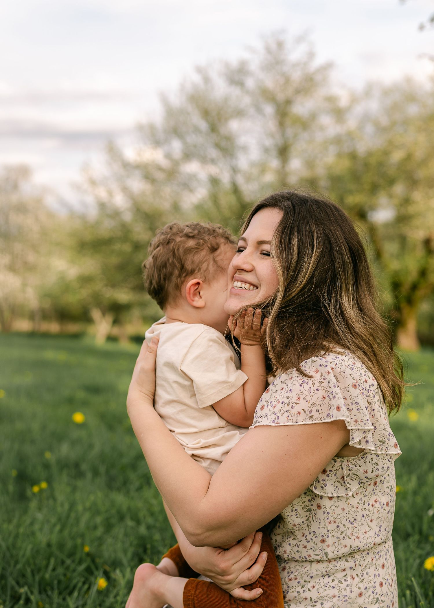 Tender moment shared between parent and child in spring garden setting.