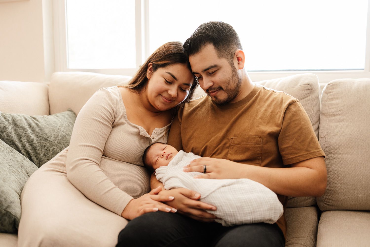 Bay Area Newborn Photographer Cindy Tucey photographs family on sofa at in-home newborn lifestyle session in Campbell