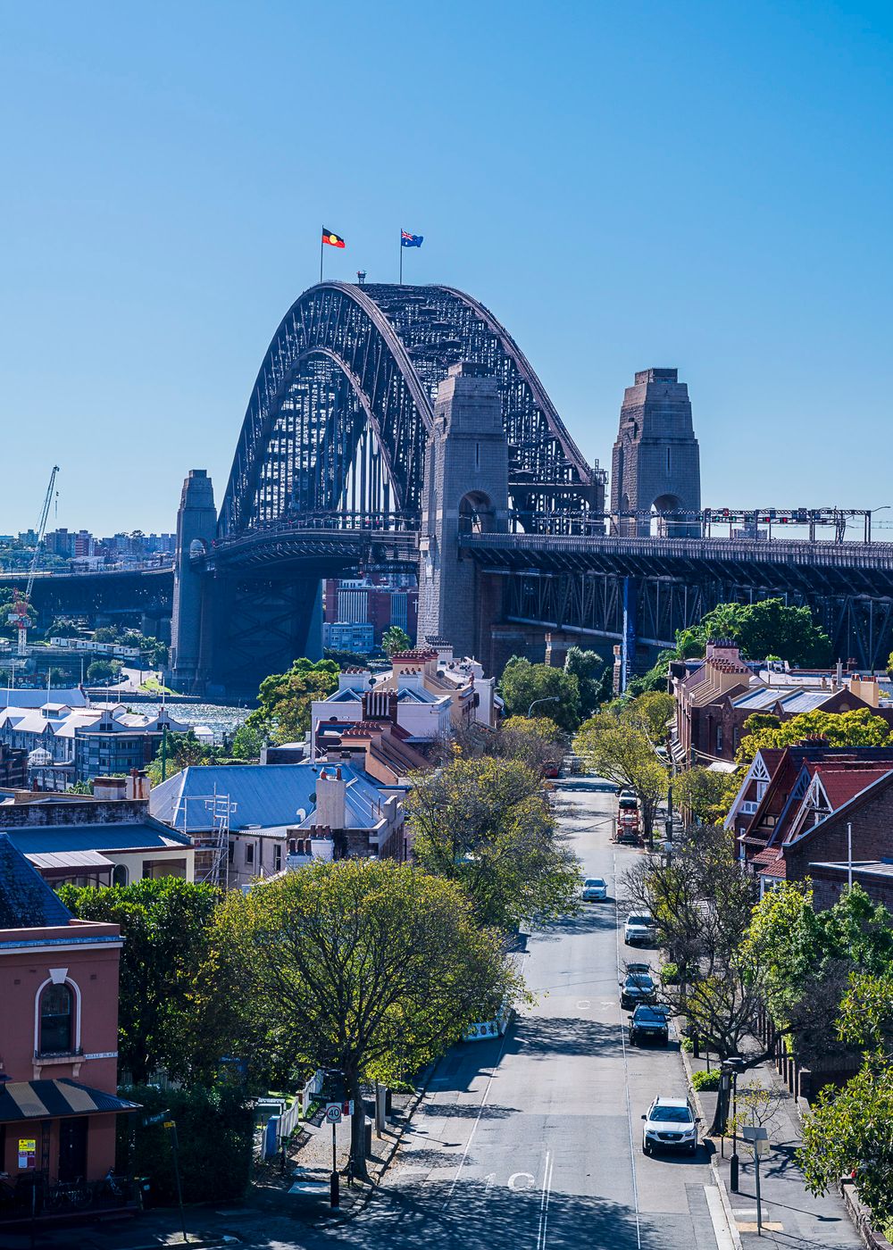 Sydney Harbour Bridge viewed from a residential street in The Rocks, Sydney, Australia, on a clear sunny day.