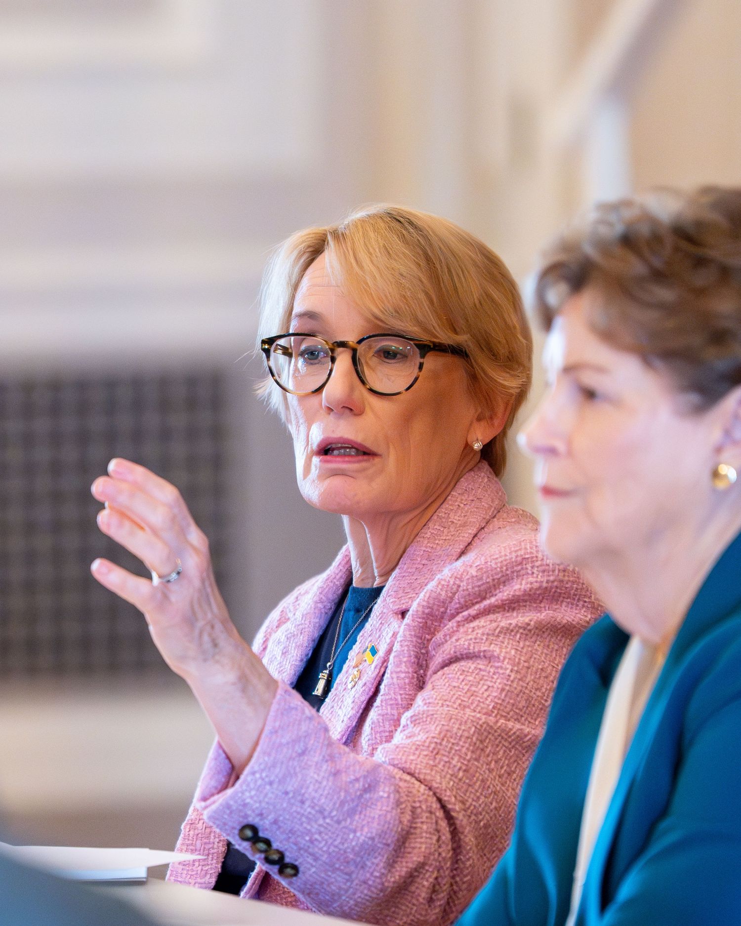 Senator talks at round table event in Manchester, New Hampshire. She looks confident and empowered as she speaks.