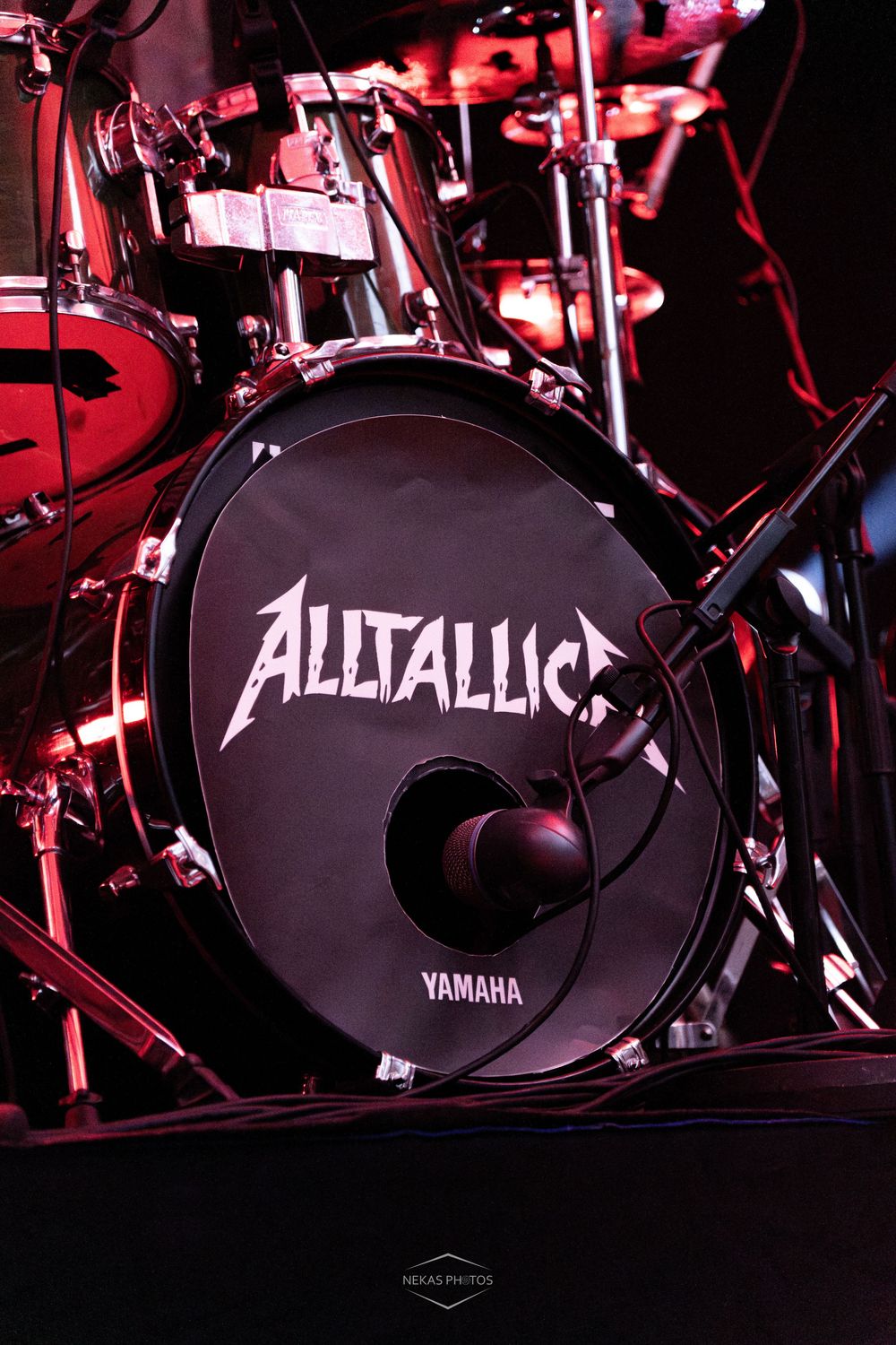 Yamaha bass drum with Alltallica logo on stage at a live metal concert performance.