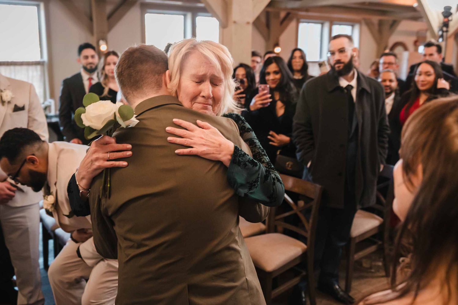 Emotional moment between groom and mother hugging before wedding ceremony at Briar Barn Inn