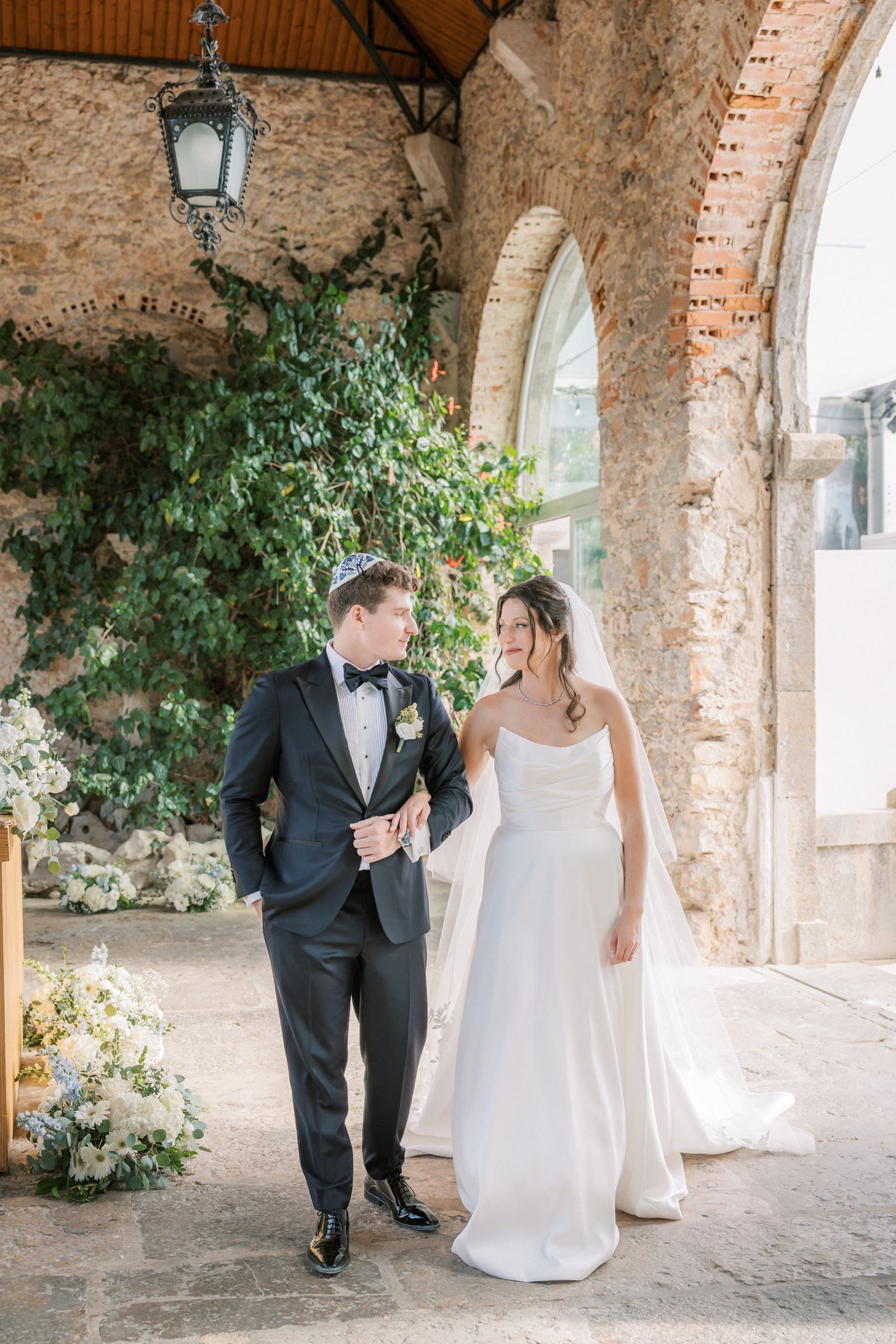 Bride and groom sharing intimate first look before wedding ceremony by the sea