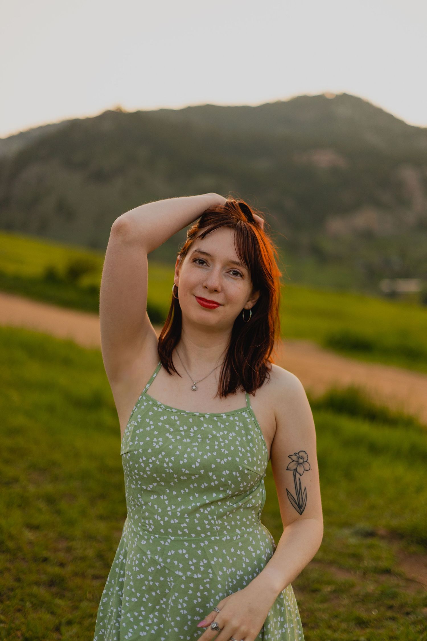 CU Denver graduate smiling with greenery behind photographed by a Boulder Senior Photographer