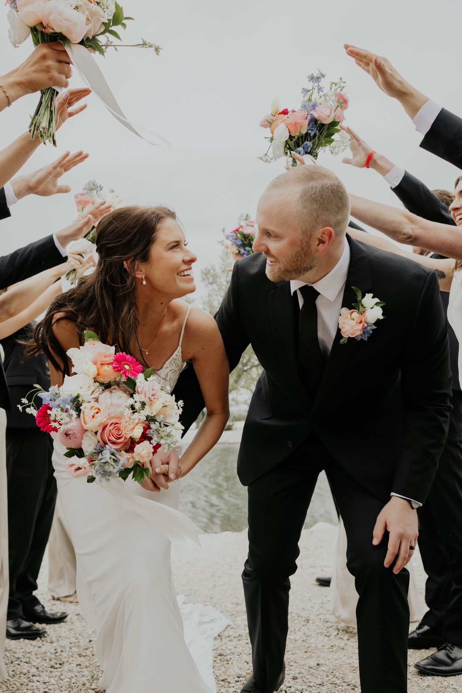Minnesota Wedding Photographer captures bride and groom amongst wedding party celebrating.