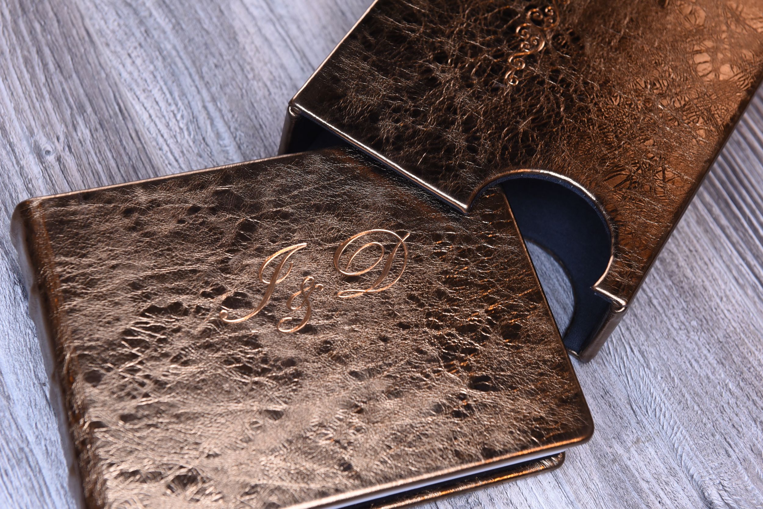 Brown leather wallet with textured surface displayed on light wooden background.