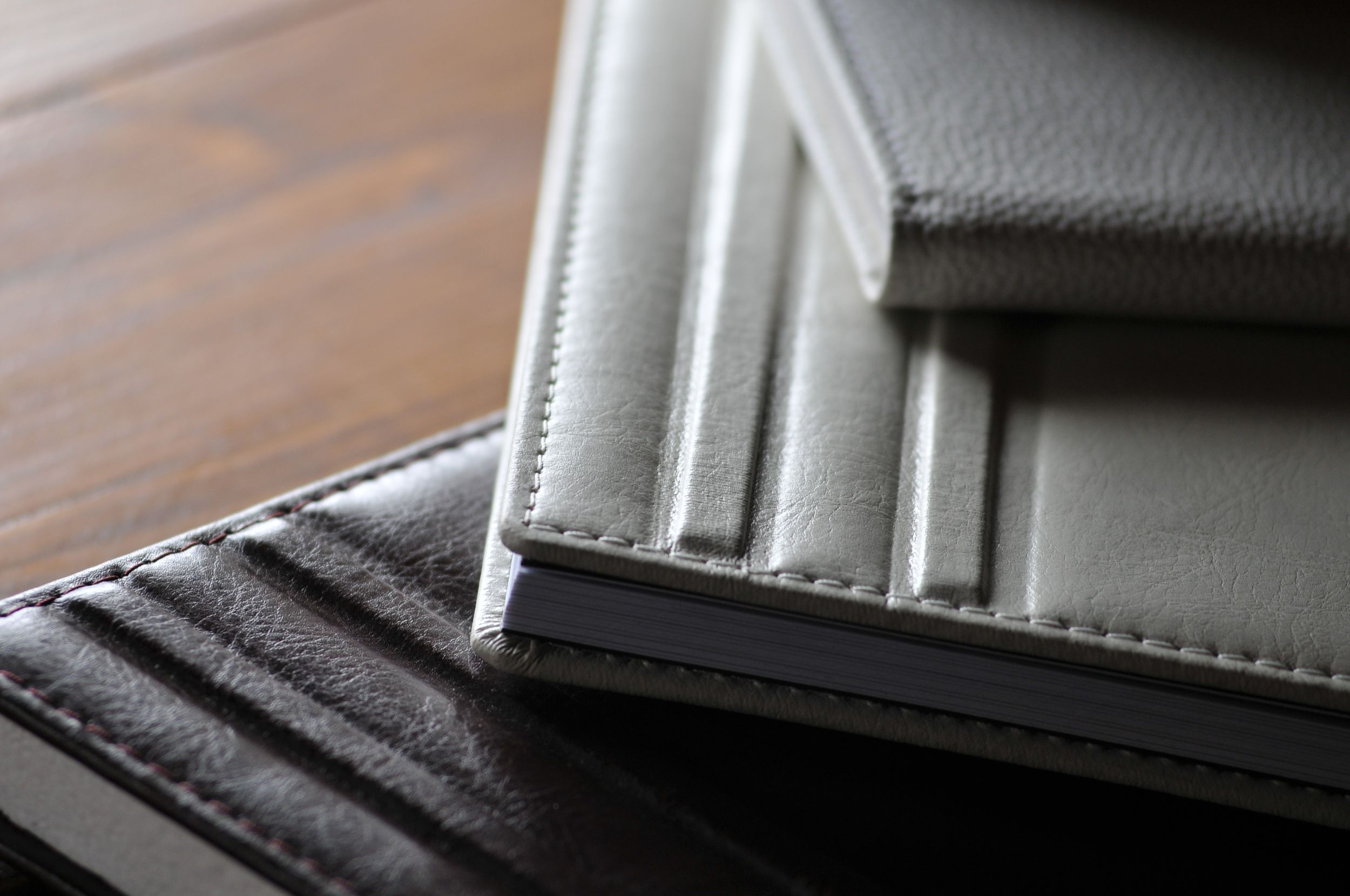 Close-up view of two leather wallets showing detail of the stitched edges and card slots.