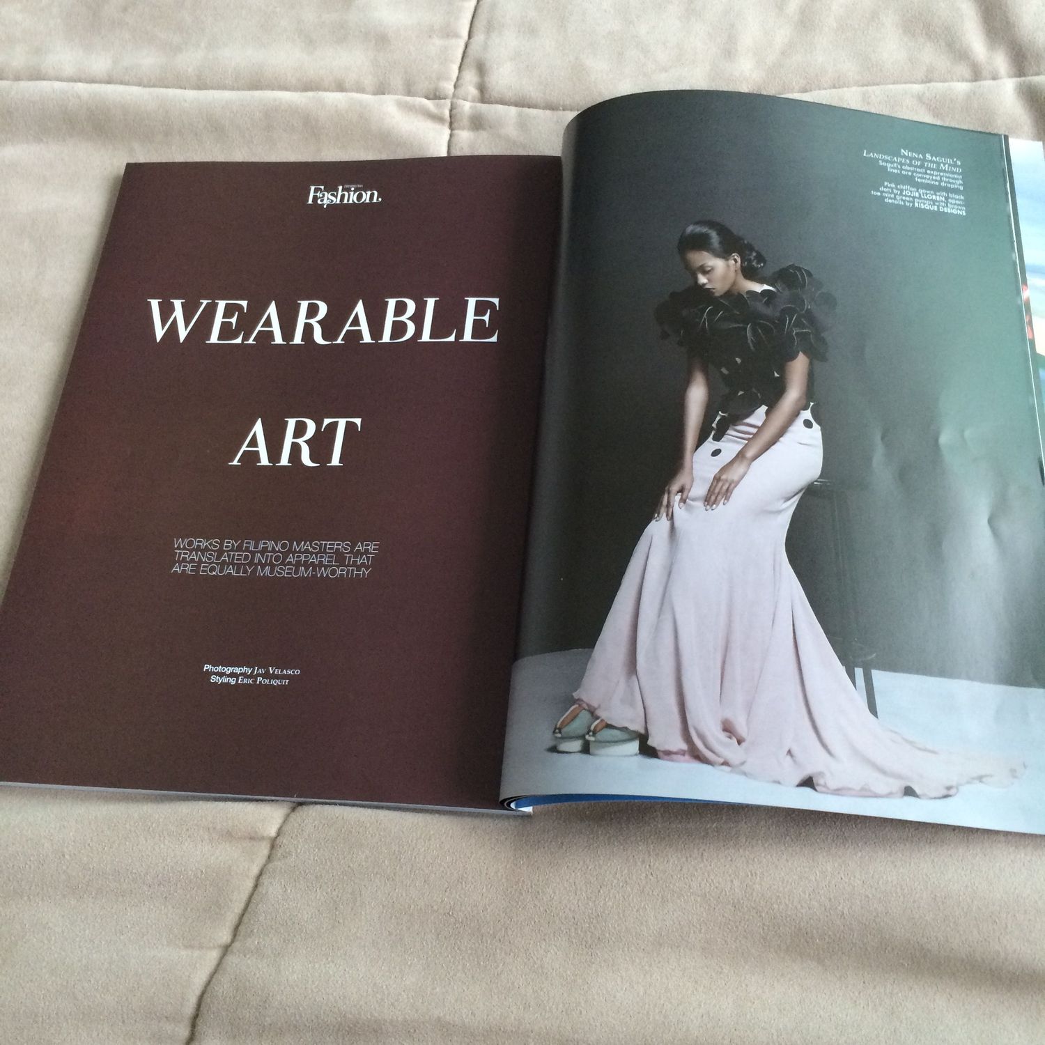 Open fashion magazine showing Wearable Art editorial with model in pink gown and black ruffled top on white background.
