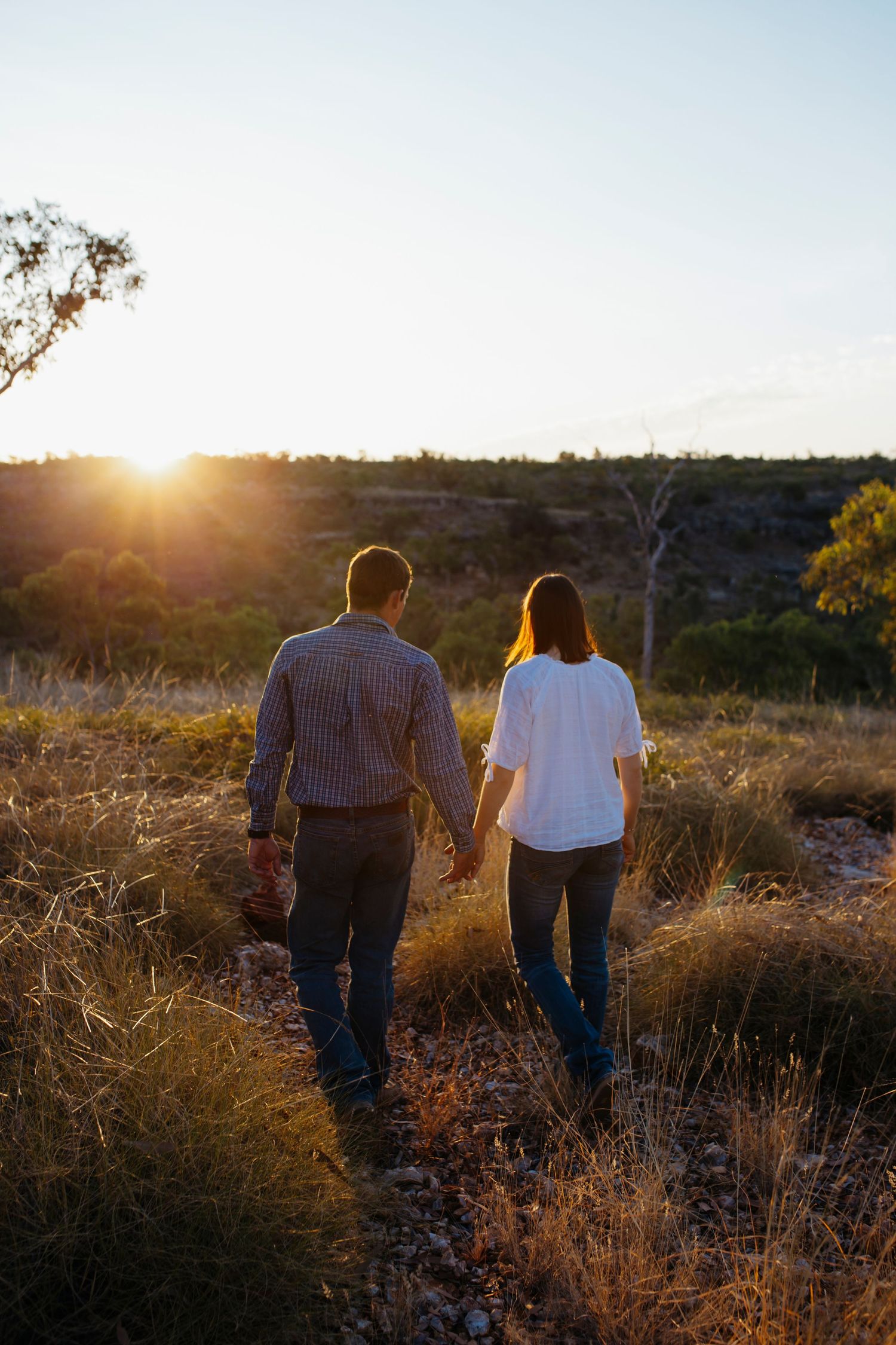 couple walking in the sunset during engagement photoshoot