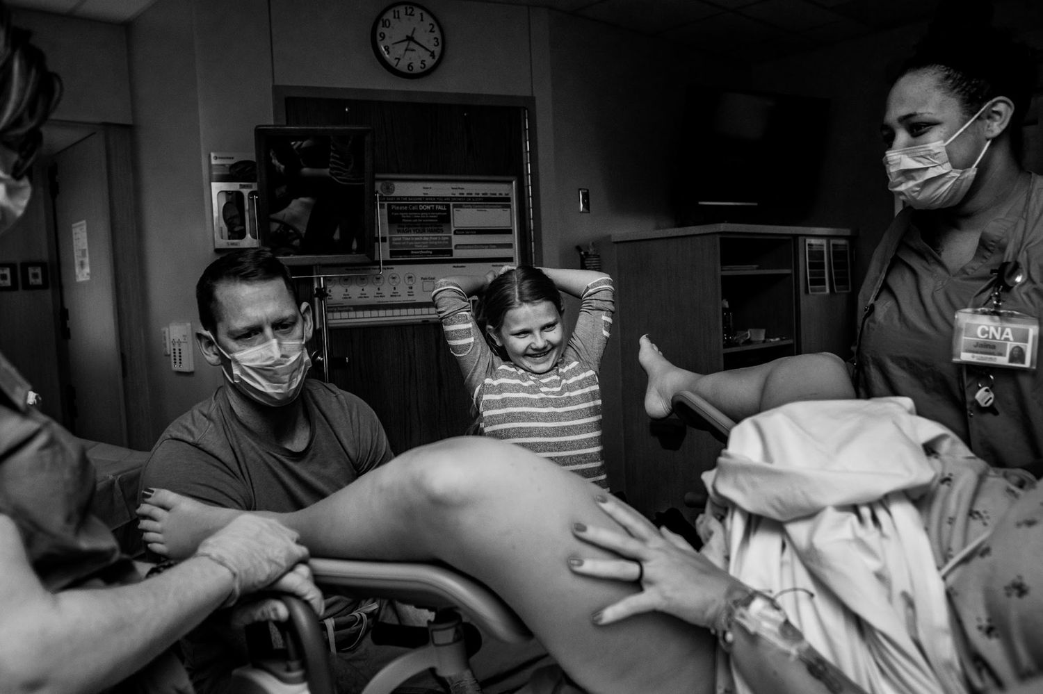 Medical team assists during childbirth in a hospital delivery room.