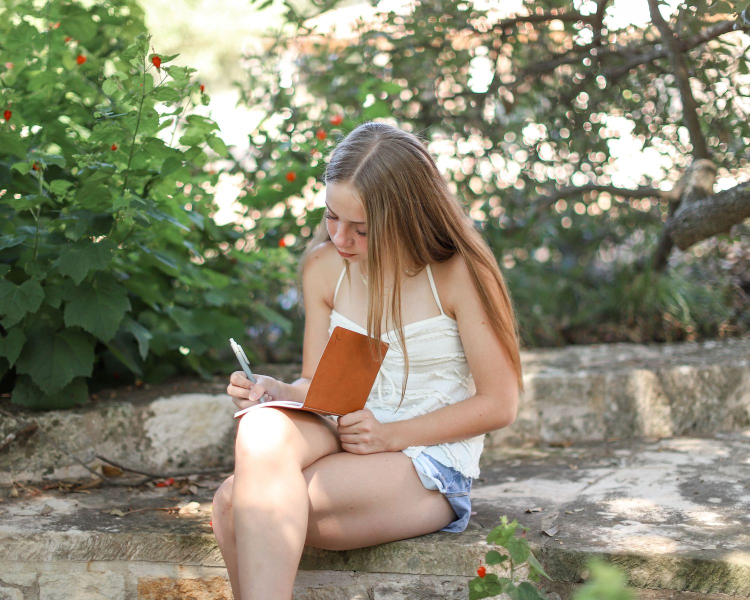 Freshman student writing in a journal during her Legacy Series session