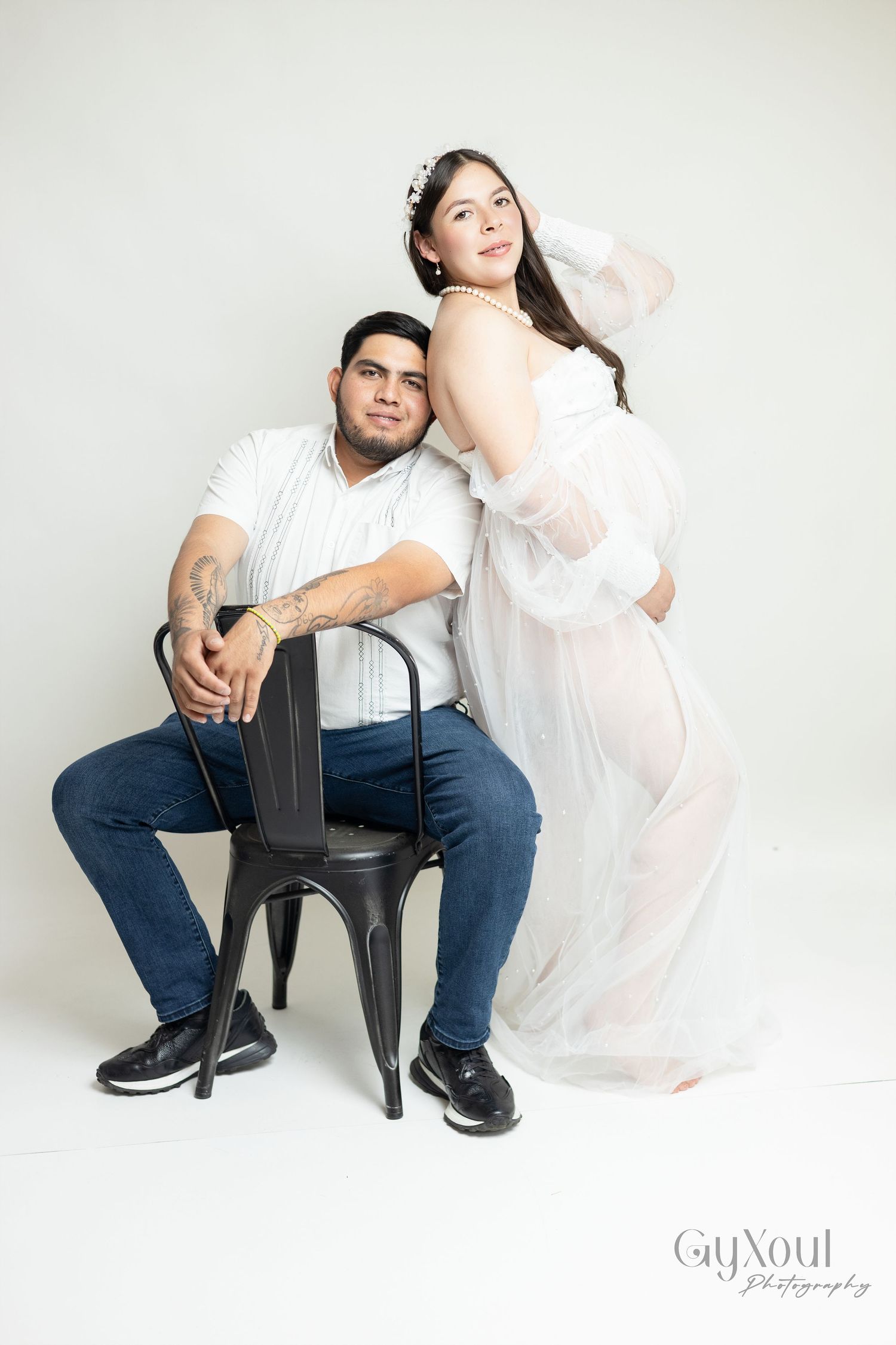 Artistic wedding photography series showing couple in white and navy blue posing against neutral backdrop in studio setting.