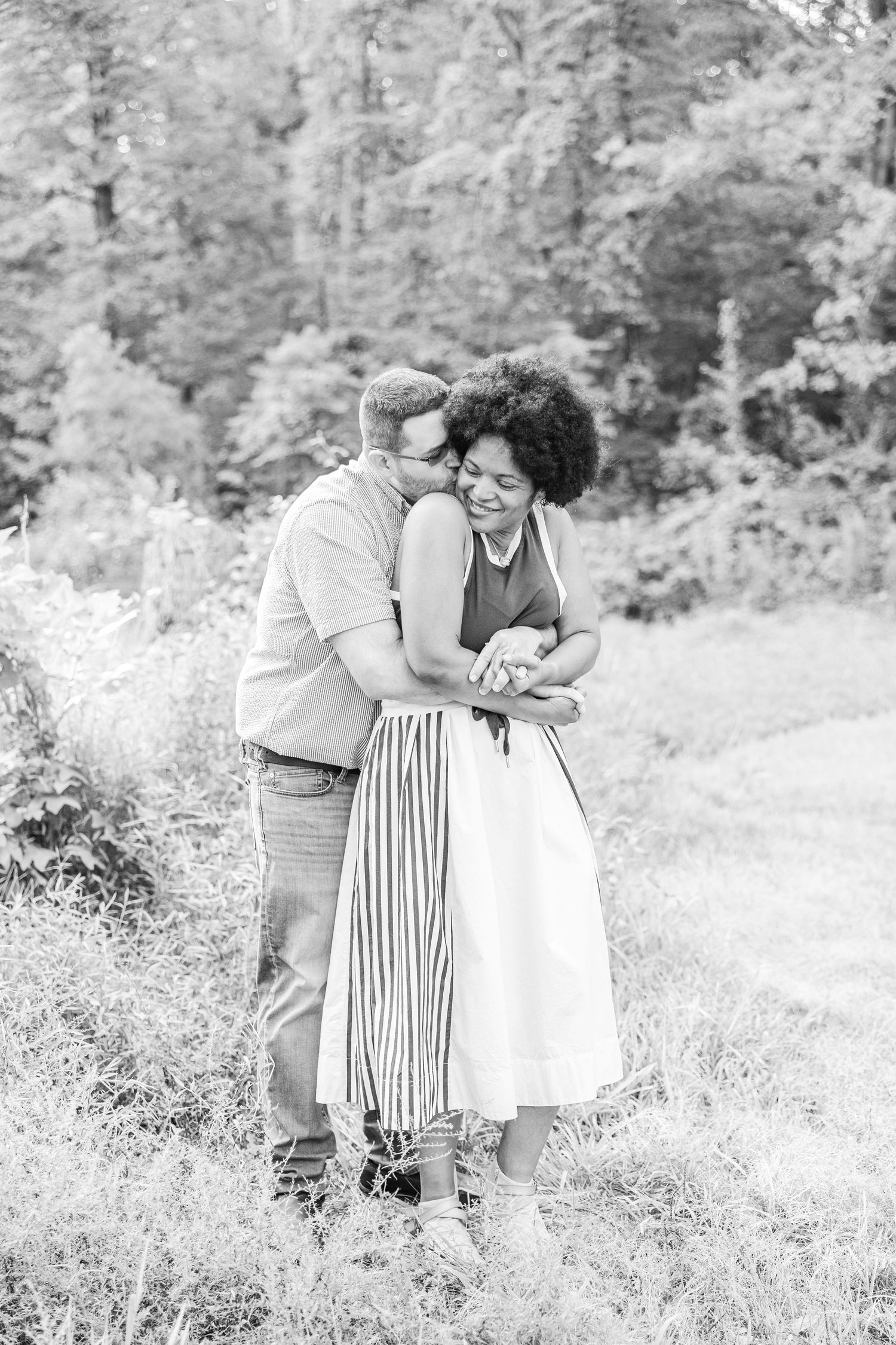 Black and white romantic portraits in outdoor meadow setting.