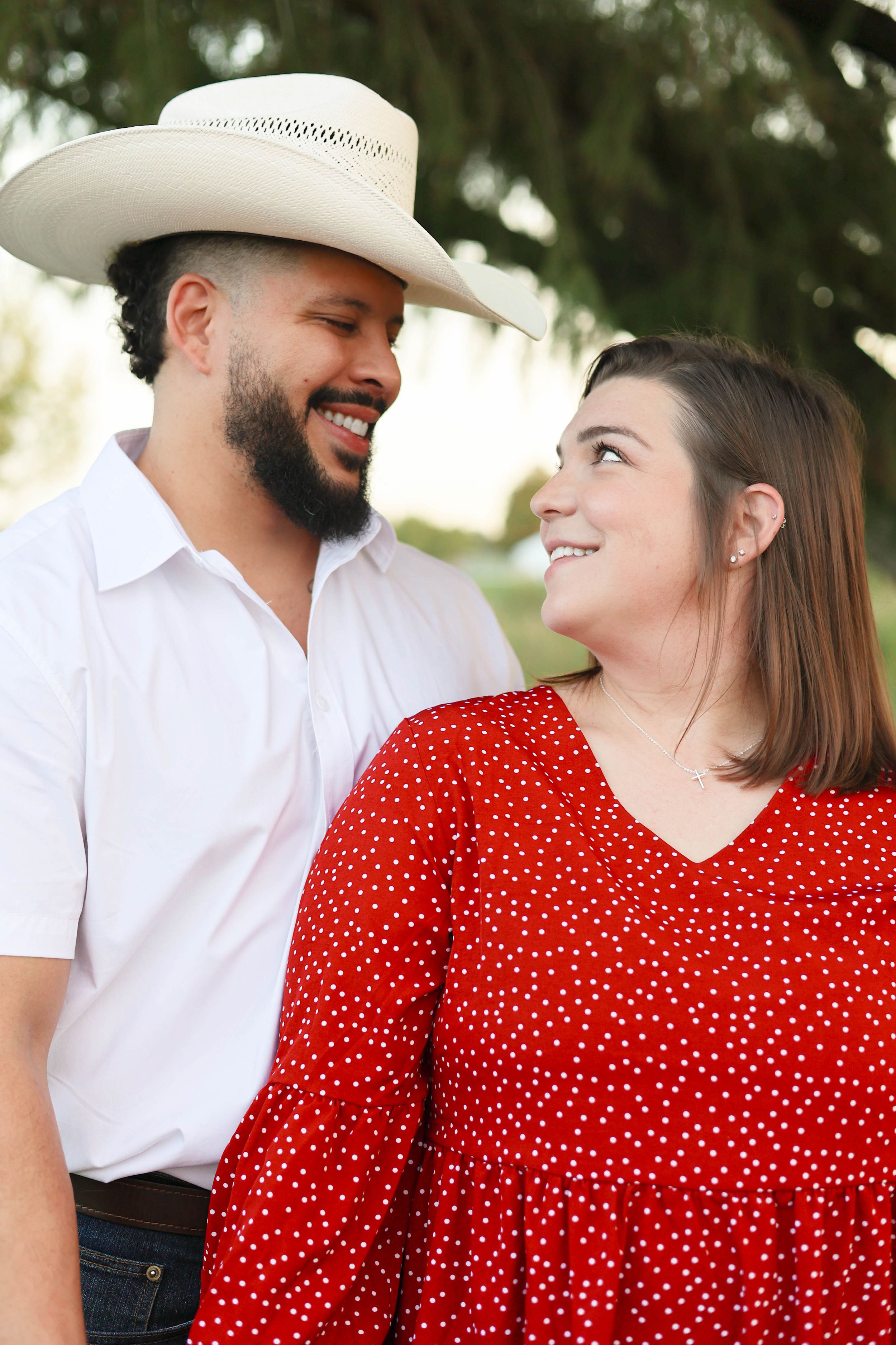 Couple under tree during golden hour.