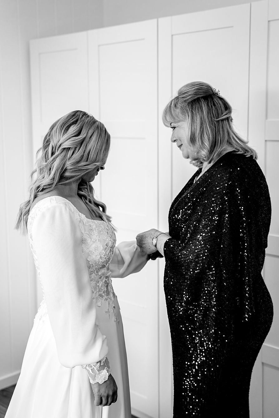 A series of black and white photos showing a tender moment between two people in formal attire.