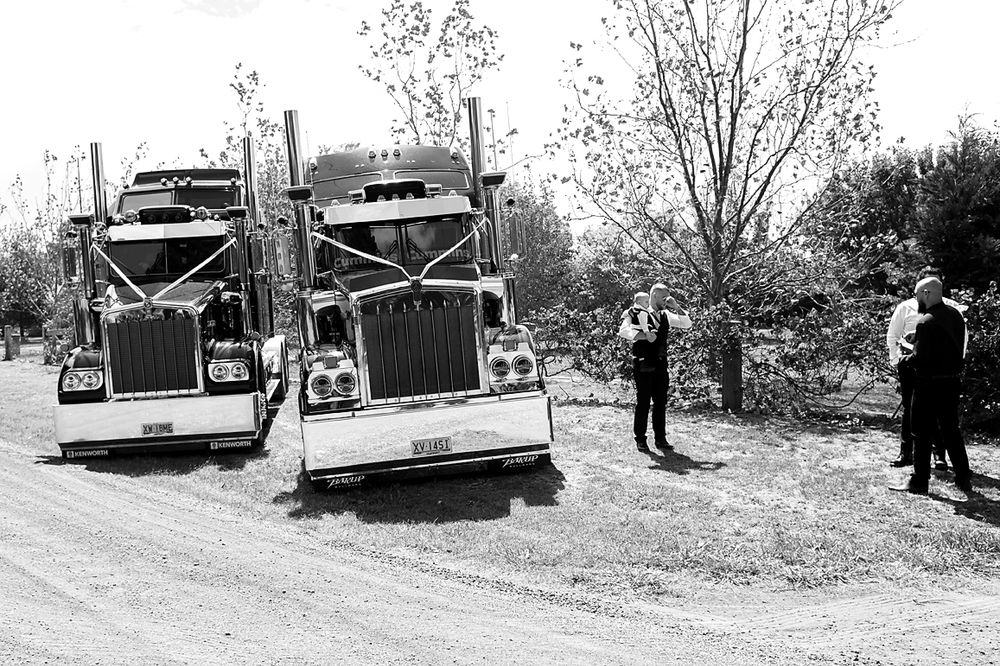 Vintage black and white photo series showing antique cars and people gathered on a rural dirt road.