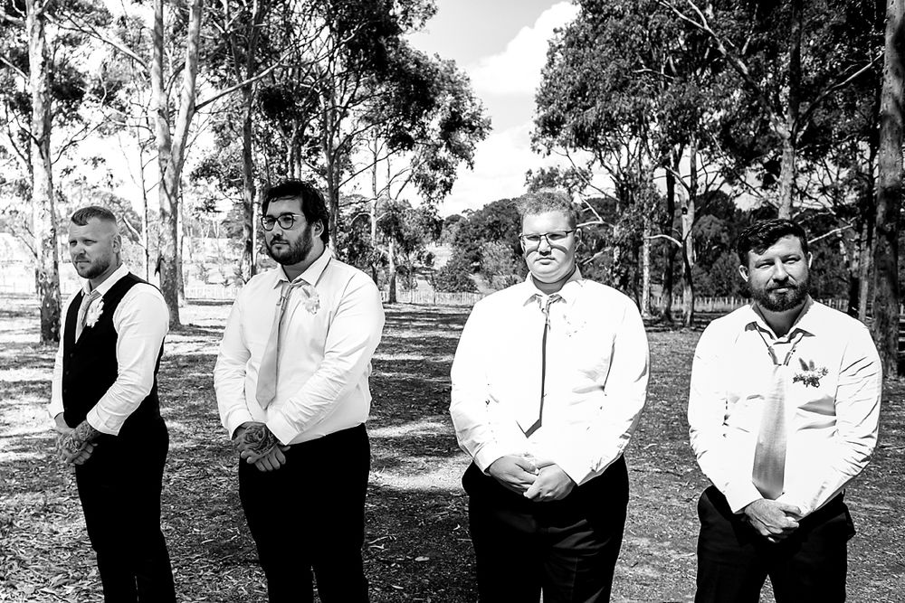 A sequence of black and white wedding photos showing candid moments between a couple and wedding party outdoors.