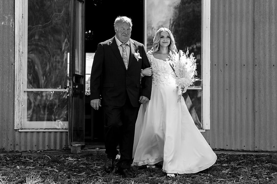 A series of black and white wedding photos showing romantic moments between a bride and groom in various outdoor settings.
