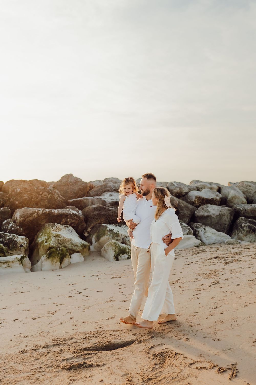Relaxed family portrait with ocean background on Bournemouth beach, Dorset
