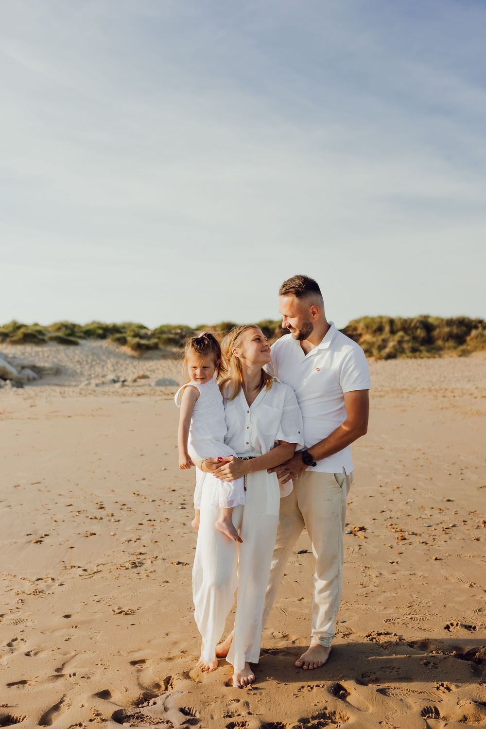 Family hugging by the sea in Bournemouth, Dorset beach family photography