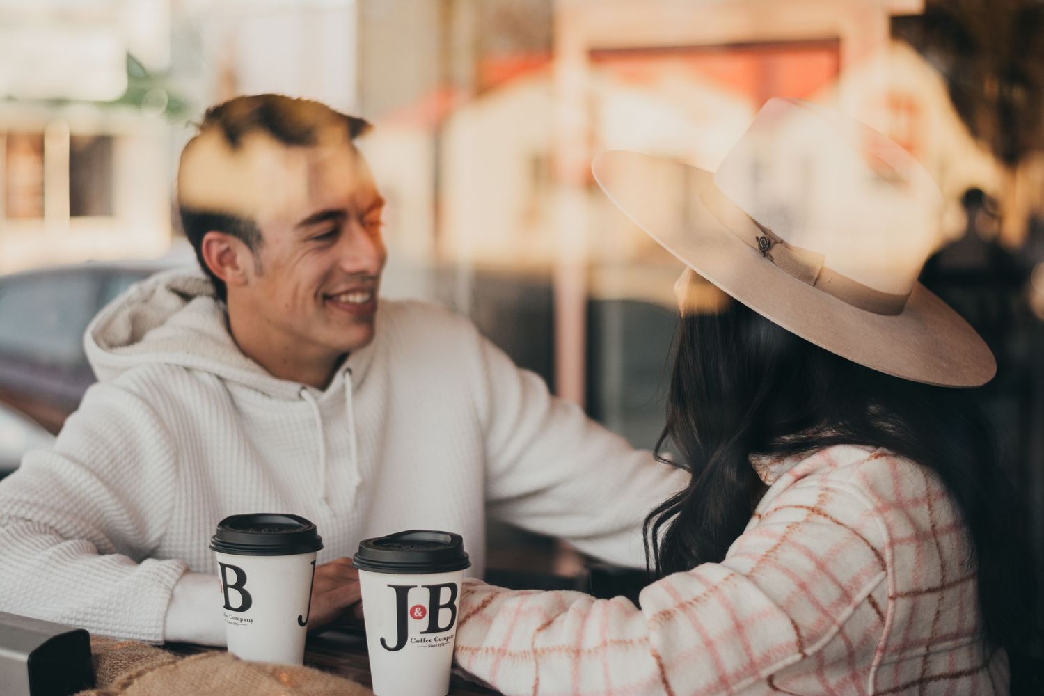 Couples photo session, a couple enjoying some coffee and each other in a cafe