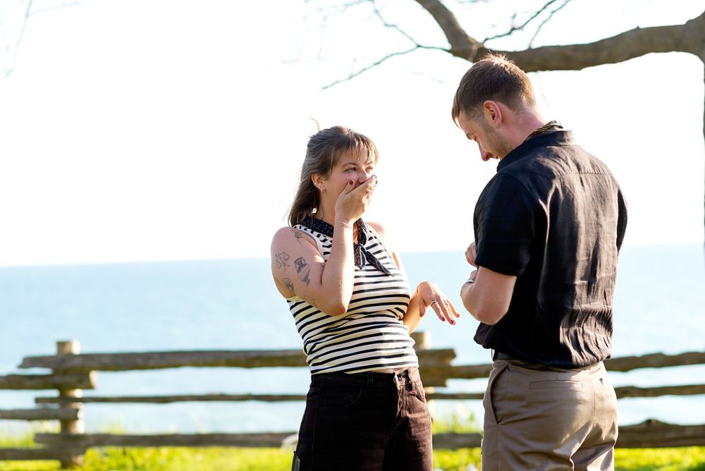 Couple sharing an intimate moment on a hilltop during sunset capture during a proposal in Bayfield.