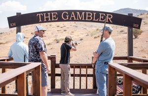 Desert landscape with wooden railing and sign reading 'THE GAMBLER' visible.