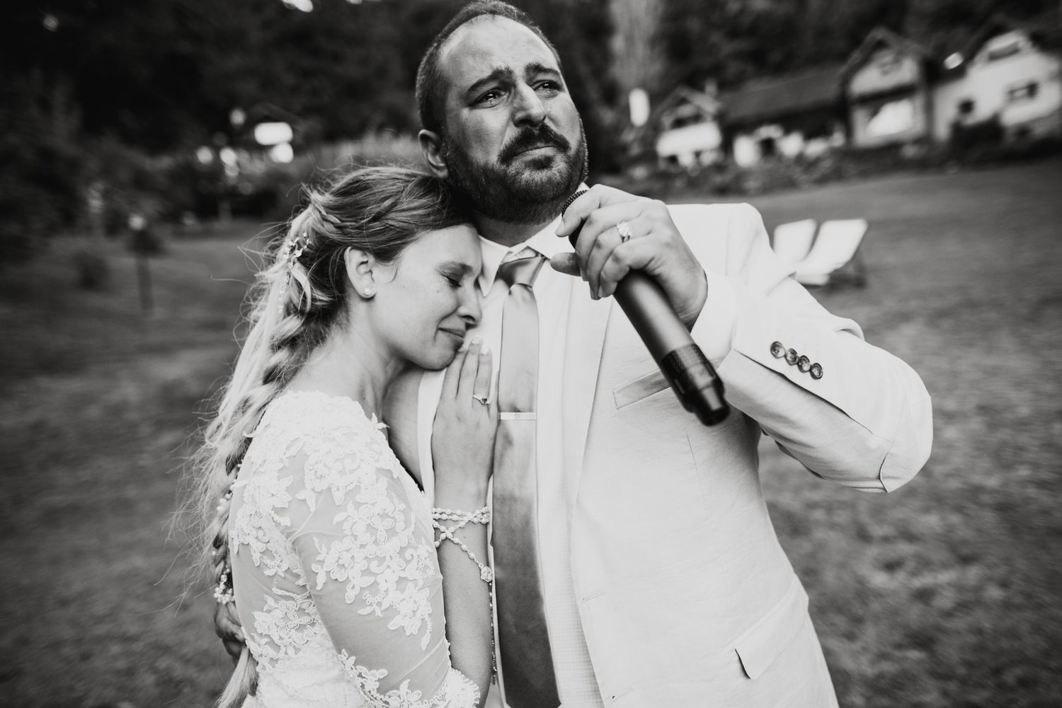 Candid black and white wedding photo capturing natural laughter and joy.