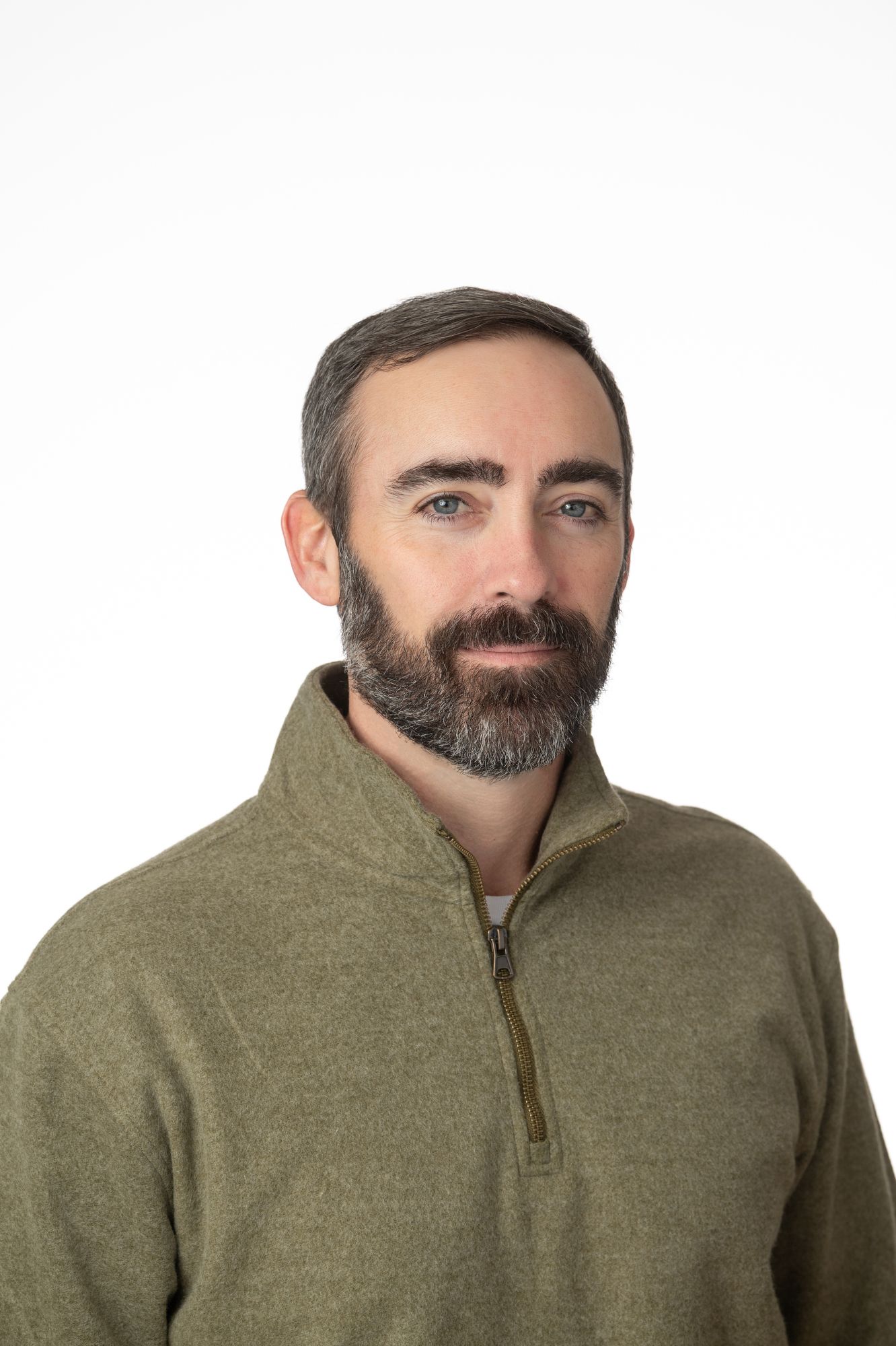 Professional headshots of a person in an olive green fleece against white background.