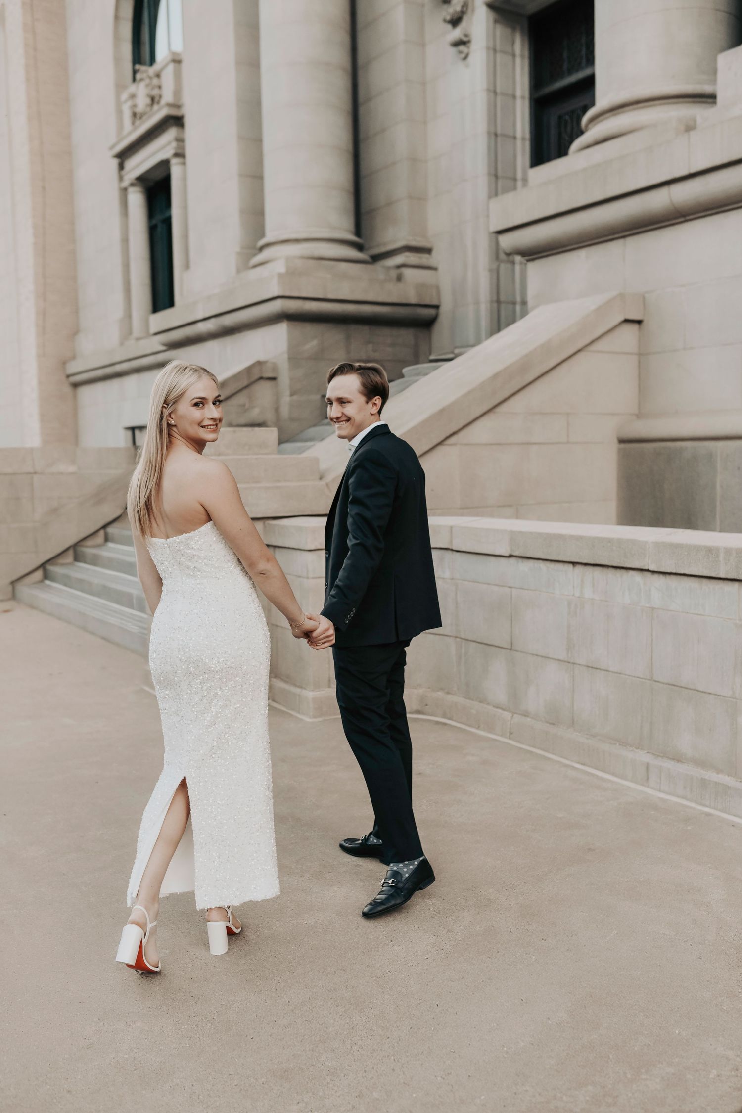 Couple walking together through downtown Dallas in modern engagement photos