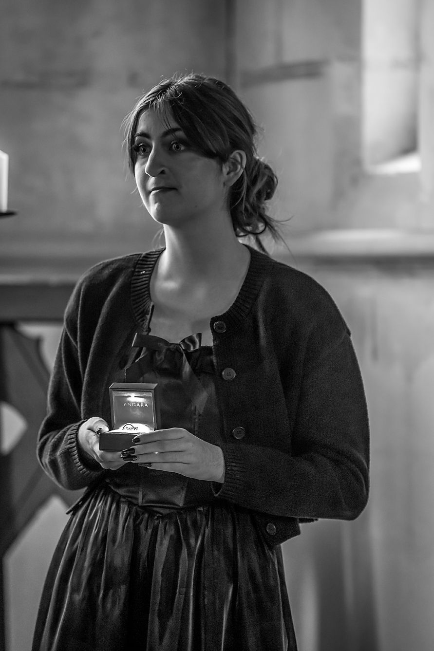 A series of black and white photos showing someone in dark clothing holding a teacup in different poses.