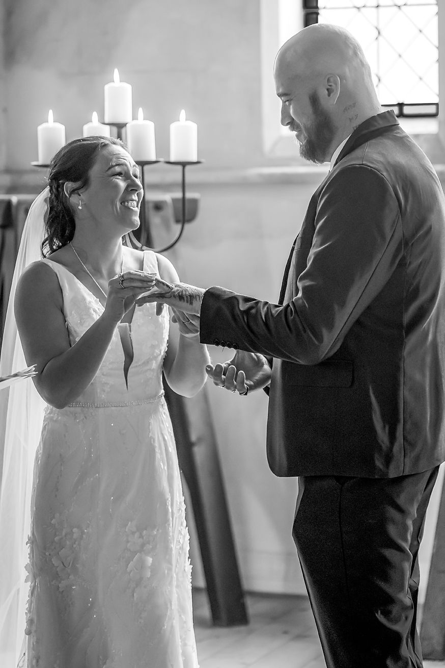 A black and white photo sequence shows a couple sharing an emotional first look moment at their wedding ceremony.