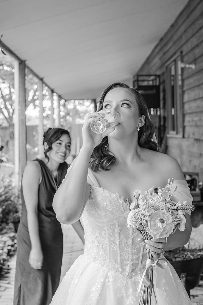 A series of black and white photos showing a bride drinking from a bottle during wedding celebrations on a porch.