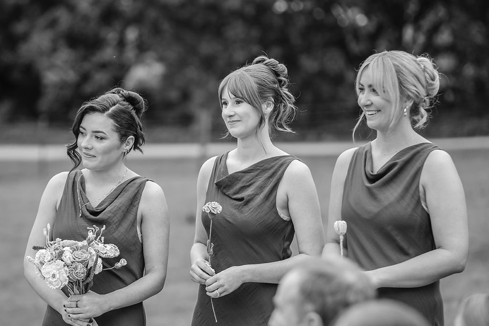 A series of black and white candid moments showing laughter and joy at an outdoor wedding celebration.