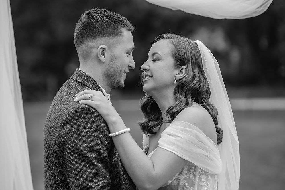 A series of intimate black and white wedding photos capturing romantic moments between newlyweds.