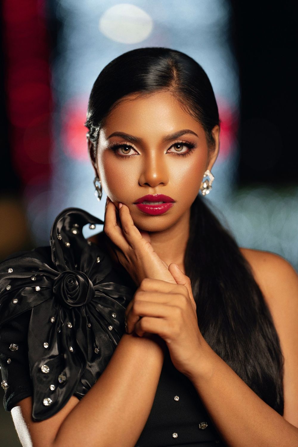 A fashion portrait series showing glamorous makeup and a black studded floral accessory against a blurred background.