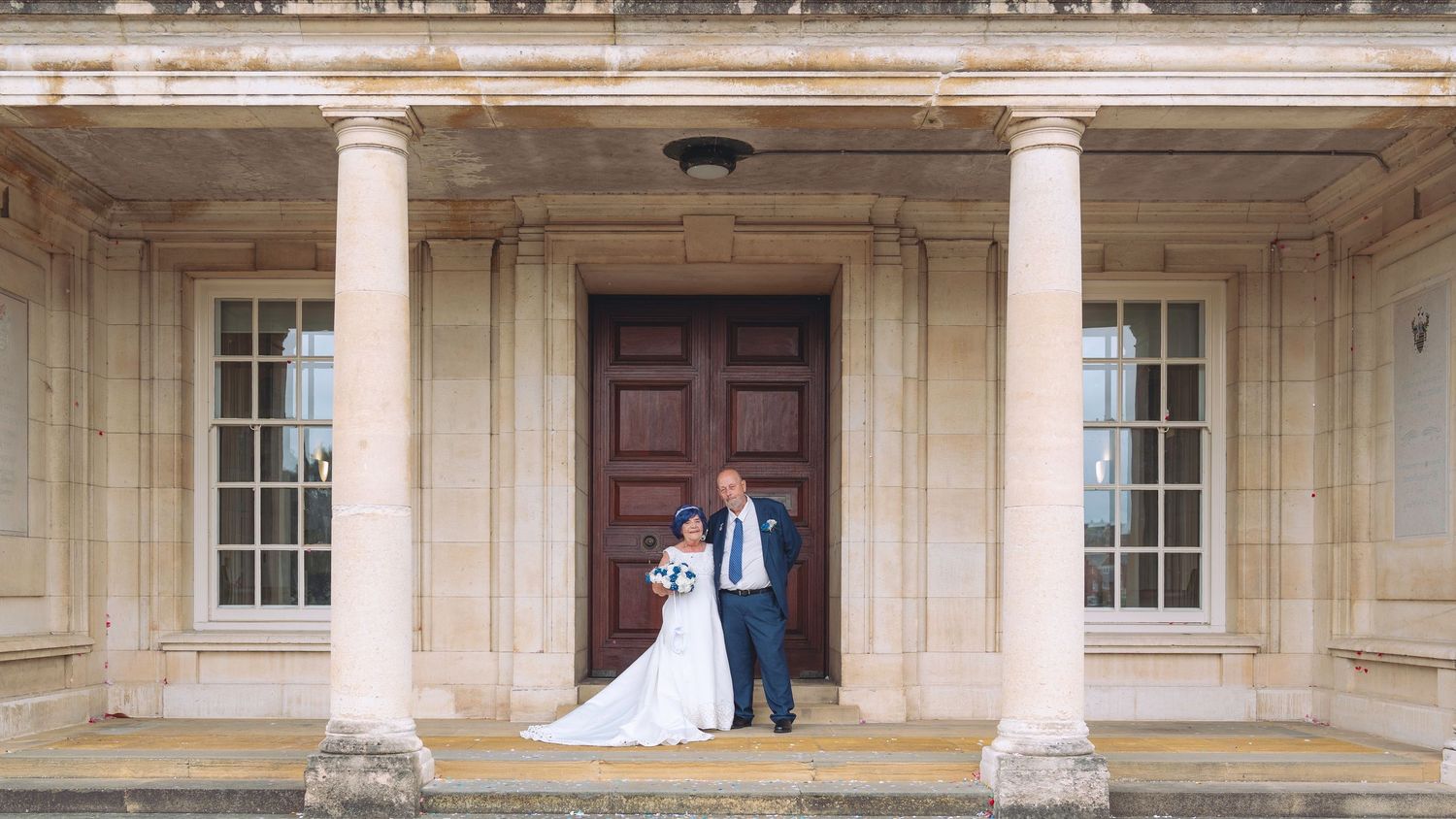A grand historic building exterior with white stone columns and arched windows in classical architectural style.