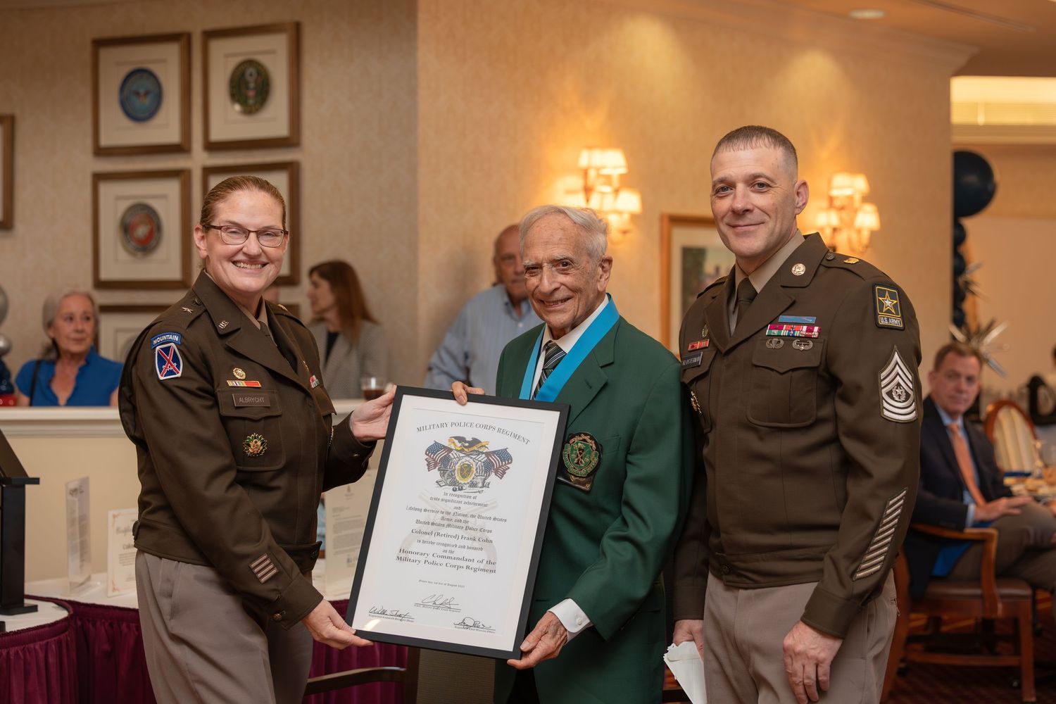 Awards ceremony in a formal dining room with certificate presentations and special recognition.