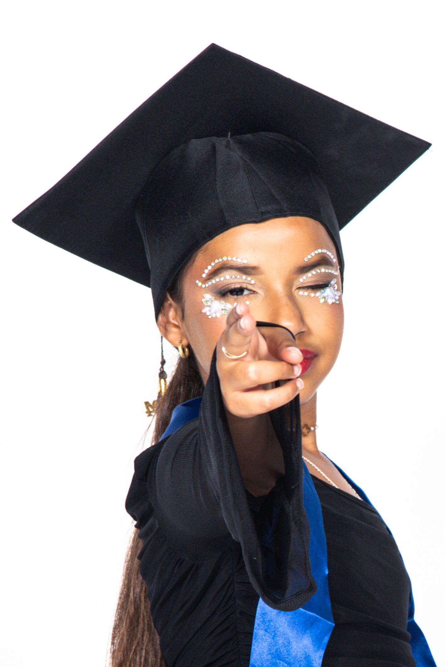 Graduate in black cap and gown with blue tassel smiling and posing in sequence of celebratory expressions.