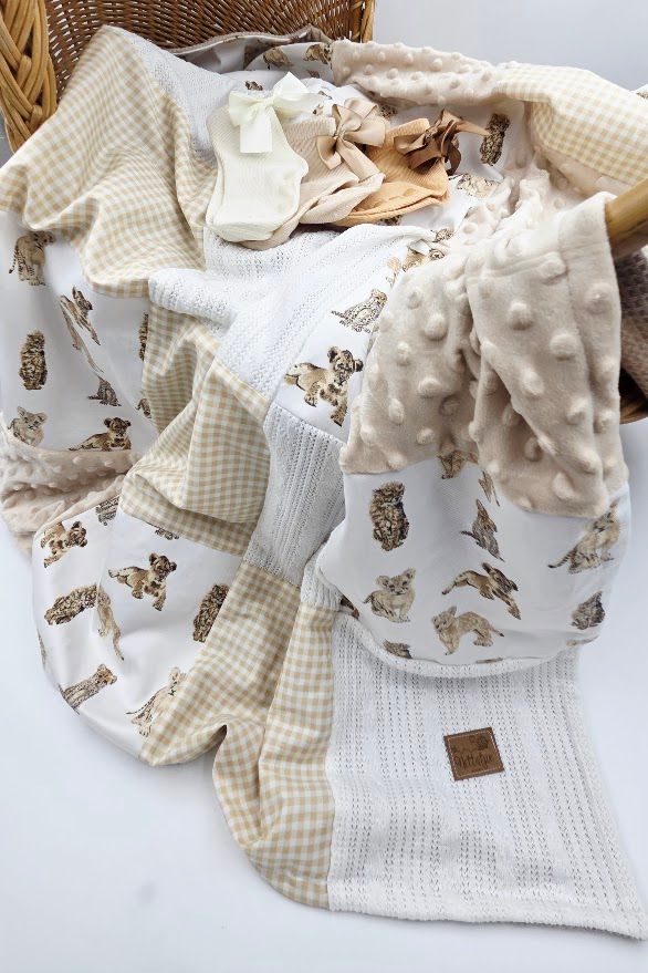 Neutral beige and white baby blanket collection featuring gingham patterns, butterfly prints, and minky dot textures.