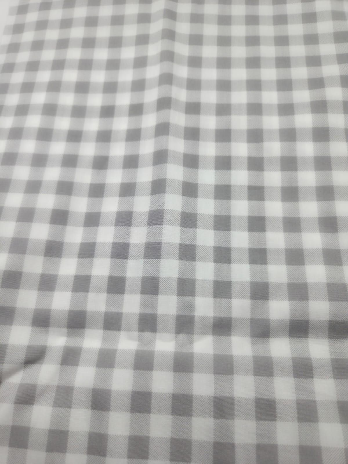 A close-up view of gray and white gingham pattern fabric showing a classic checkered design.