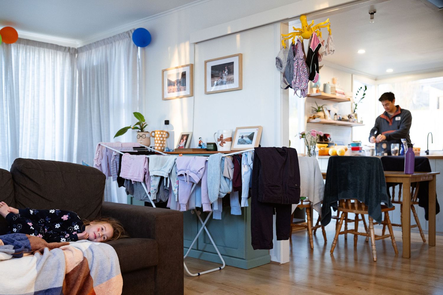 A panoramic view of a modern apartment interior with living room furniture and decorative elements.