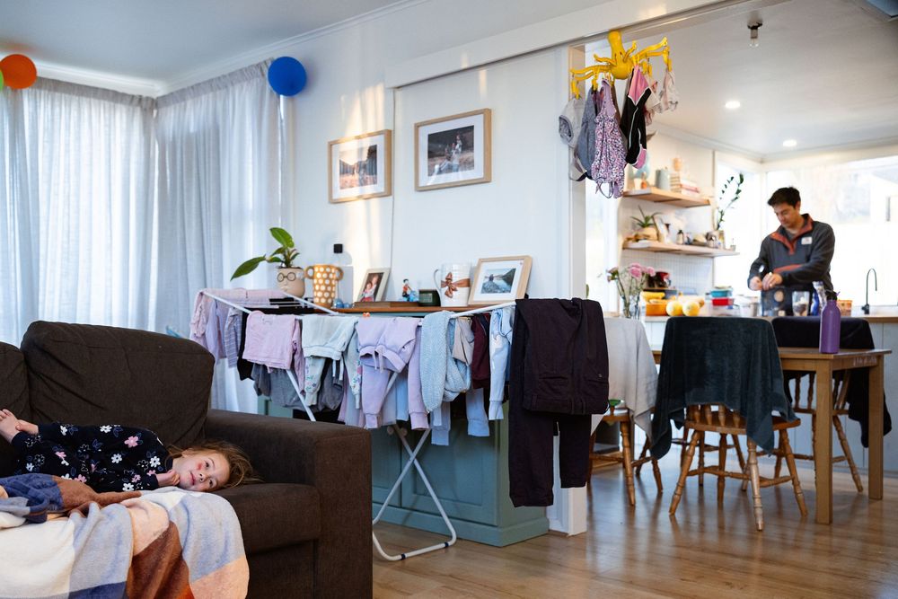 A panoramic view of a modern apartment interior with living room furniture and decorative elements.