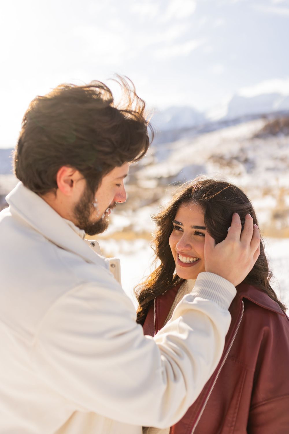 Utah couple session in snowy mountains, intimate winter engagement photo with natural light