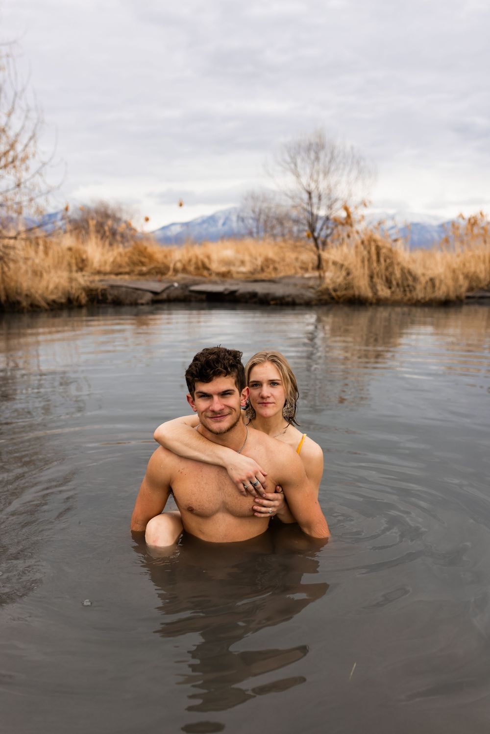 Couple portrait in natural hot spring, adventurous Utah engagement session in outdoor setting