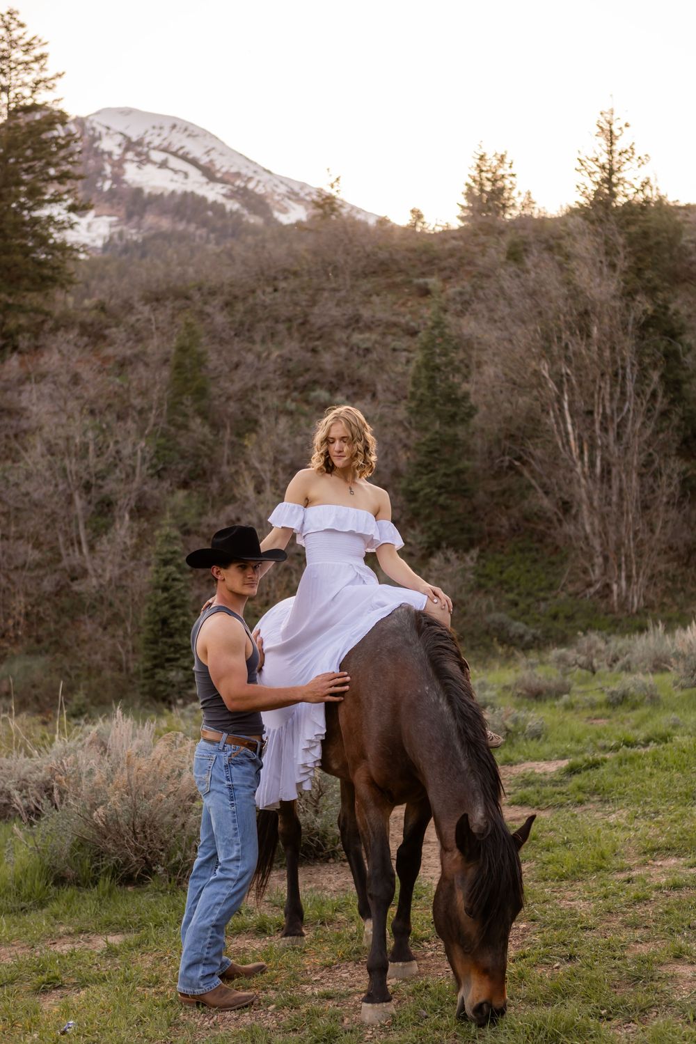 couple holding each other with their dog during a winter couples session in Utah