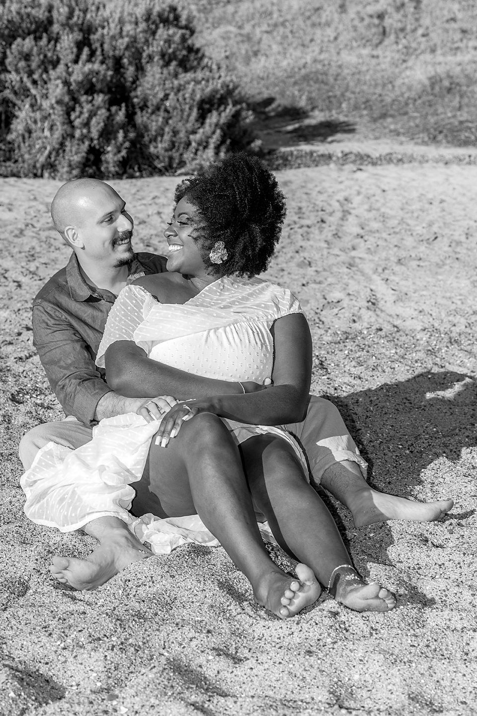 A series of vintage black and white photographs capturing intimate moments between two people relaxing on a beach.