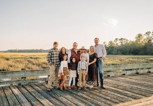 A series of candid family photos taken on a wooden deck at sunset with a golden field in the background.